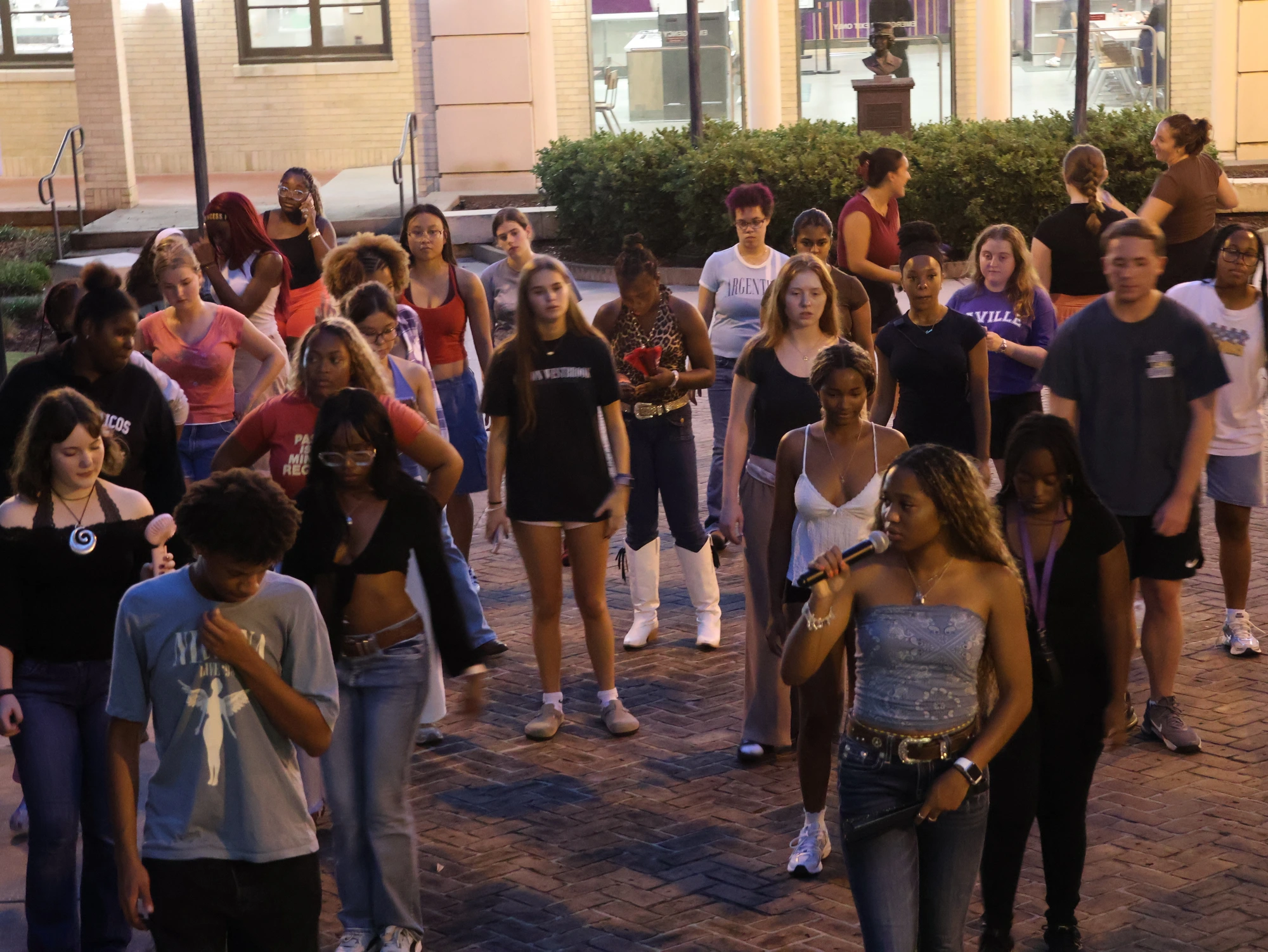 LSU students line dancing together at night on campus