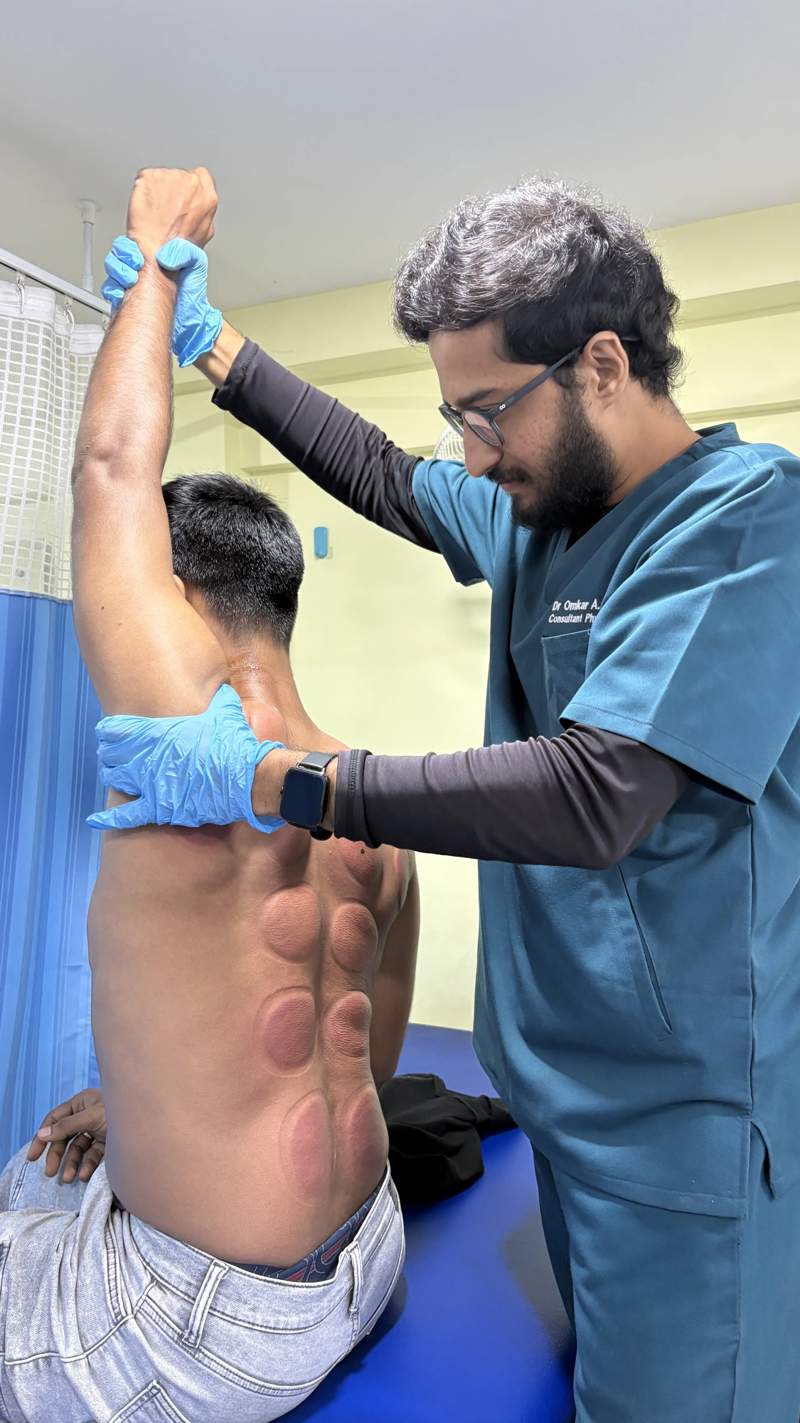 Dr. Omkar providing hands-on physiotherapy treatment