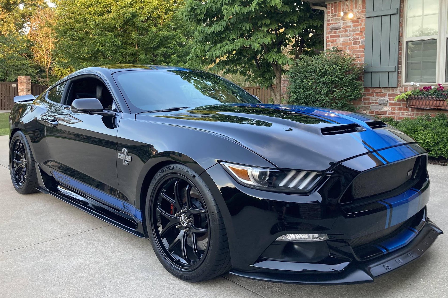 Ceramic coating on a dark vehicle body under studio lights