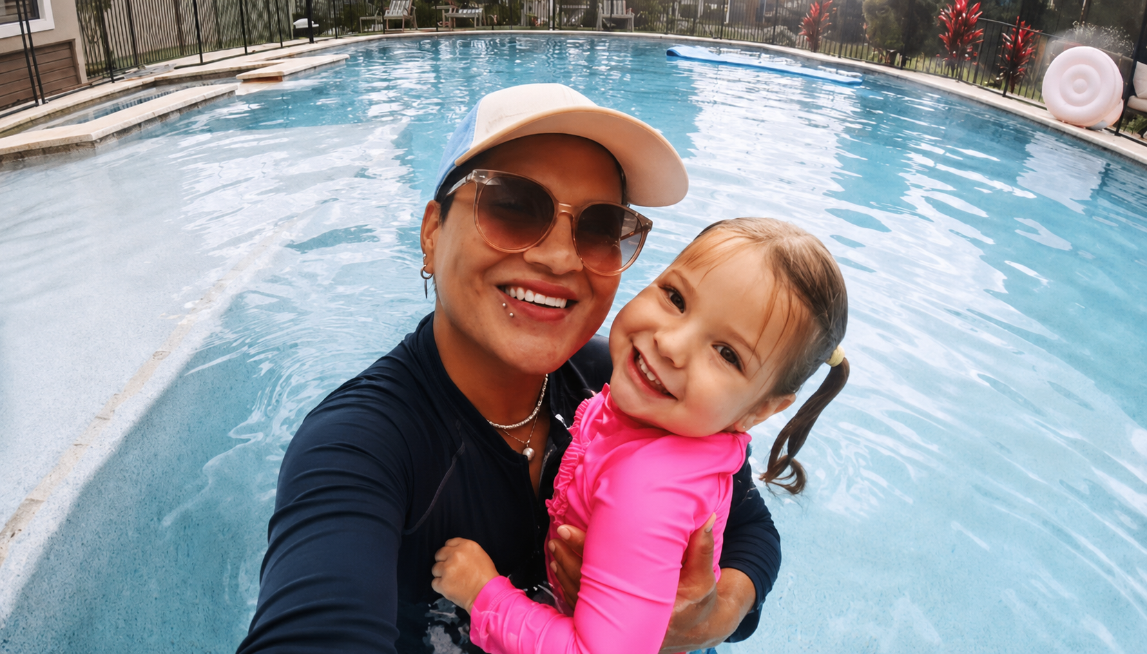 Milly with a happy young swimmer in a Boca Raton home pool